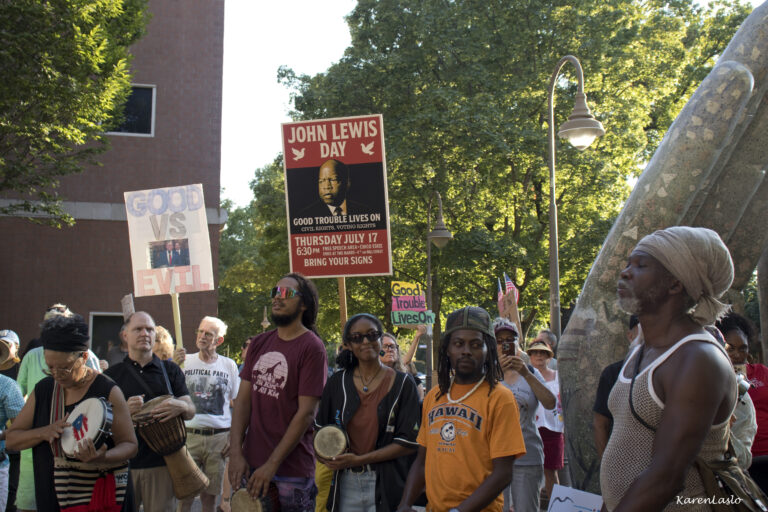 Upbeat 'Good Trouble' rally draws hundreds to city hall plaza